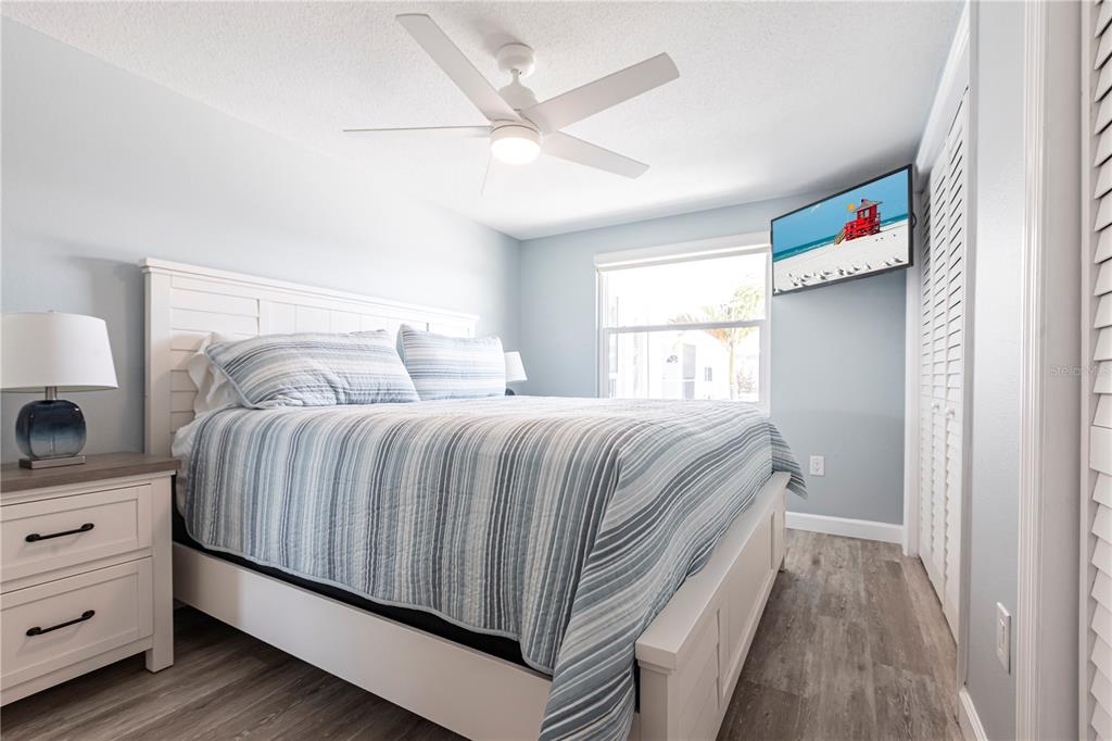 6020 Midnight Pass Road, Unit 53 Sarasota, FL 34242 - Photo 10 of 16 a bedroom with a bed and a window