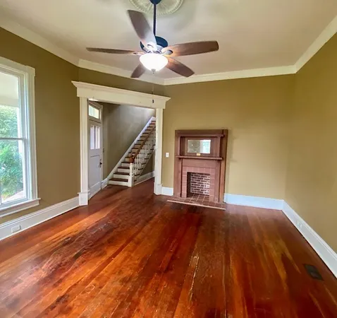 a kitchen with stainless steel appliances granite countertop a sink a stove and a wooden floors