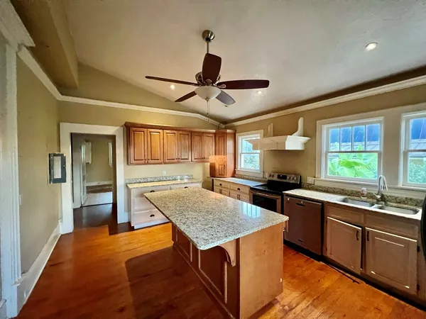 a kitchen with stainless steel appliances granite countertop stove top oven and sink