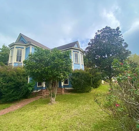 a view of living room with furniture and wooden floor