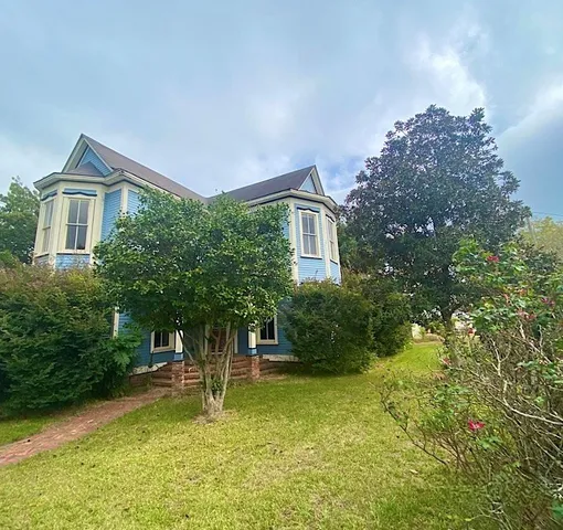 a view of living room with furniture and wooden floor