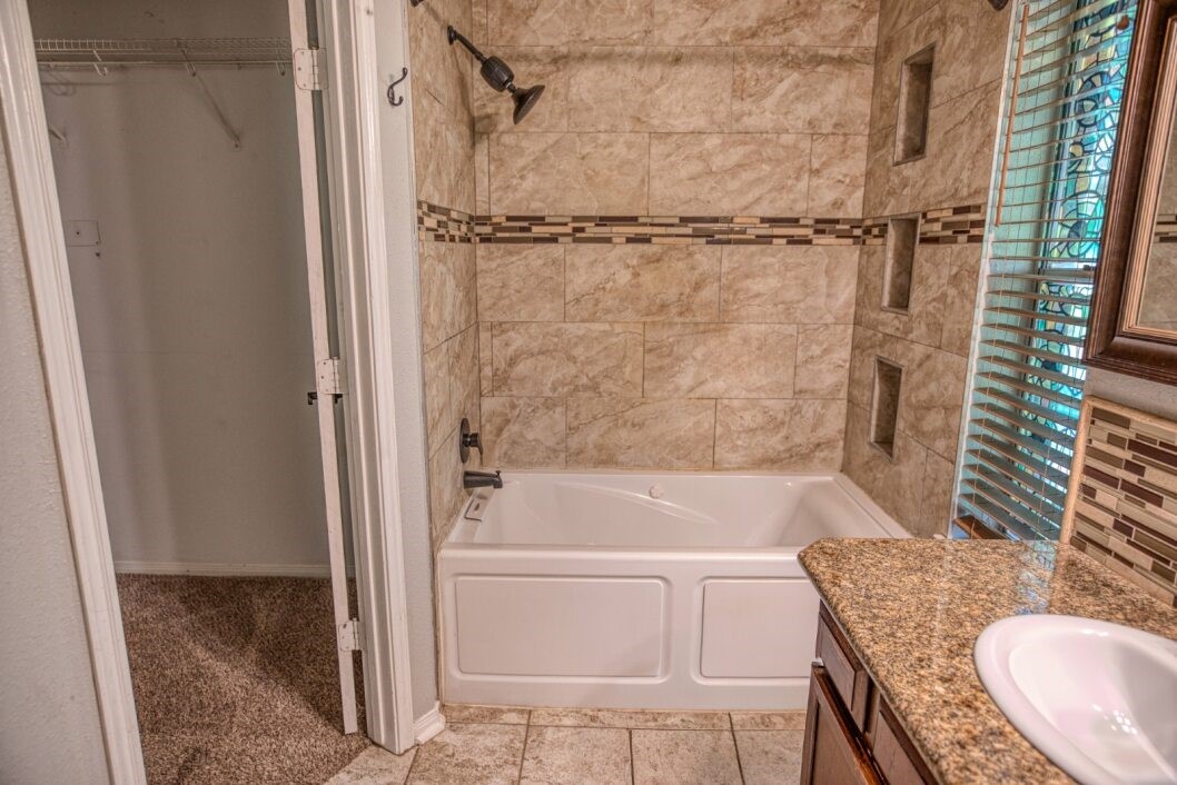 308 County Road 893B Angleton, TX 77515 - Photo 33 of 41 a bathroom with a granite countertop sink toilet and shower