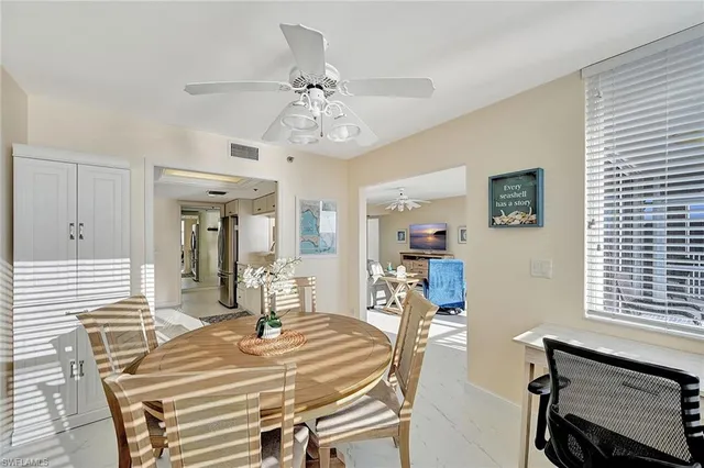 a view of a dining room with furniture wooden floor and a chandelier
