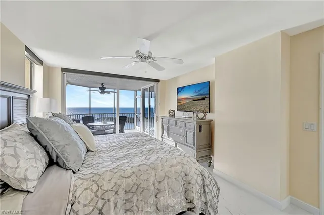 a large bedroom with a large bed and a flat tv screen