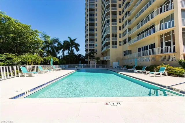a view of a swimming pool with a lawn chairs