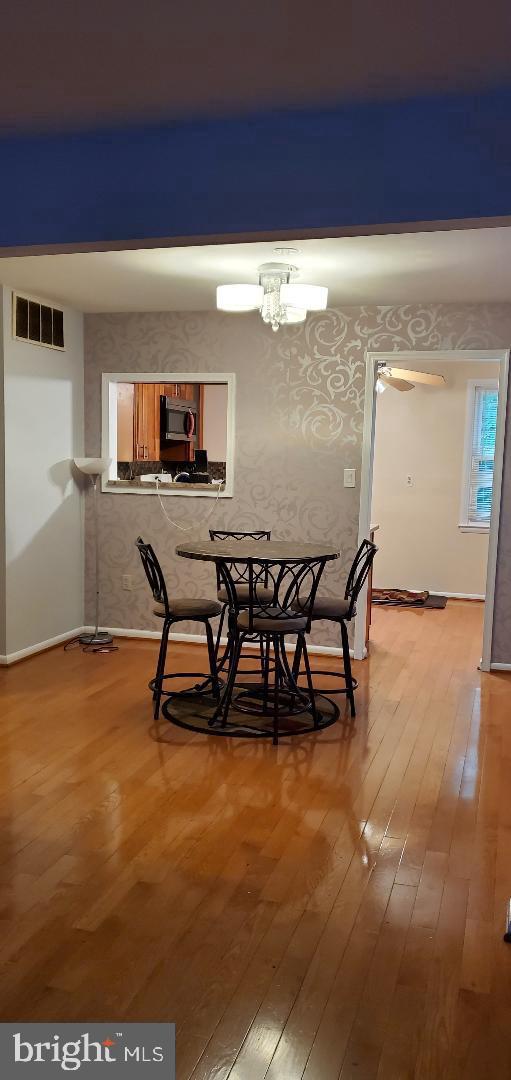 8512 Imperial Drive, Unit 1H Laurel, MD 20708 - Photo 6 of 14 a workspace with furniture and a table
