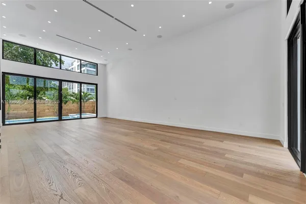 a kitchen with large windows and sink