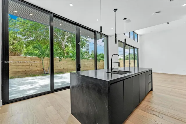 an empty room with wooden floor and a window