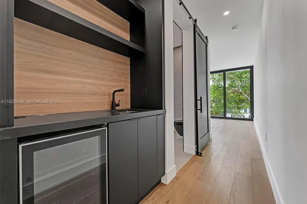 a view of empty room with wooden floor