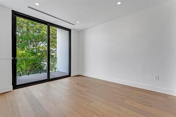 an empty room with wooden floor and closet