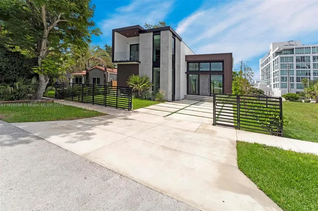 a view of a house with a yard and plants