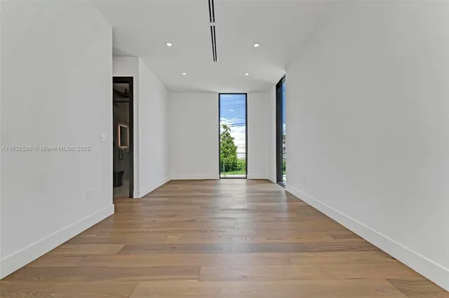 a view of a house with a small yard and a large tree