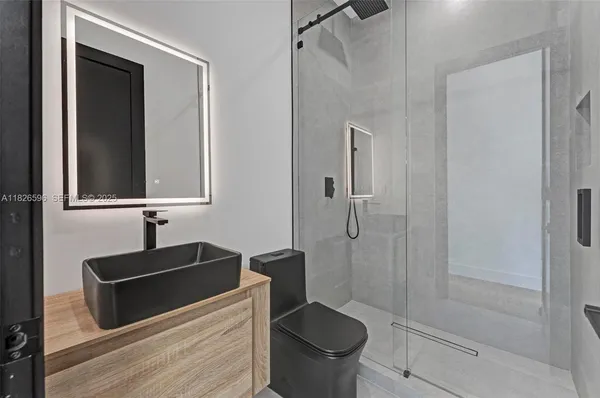 a view of a porch with a floor to ceiling window and potted plants