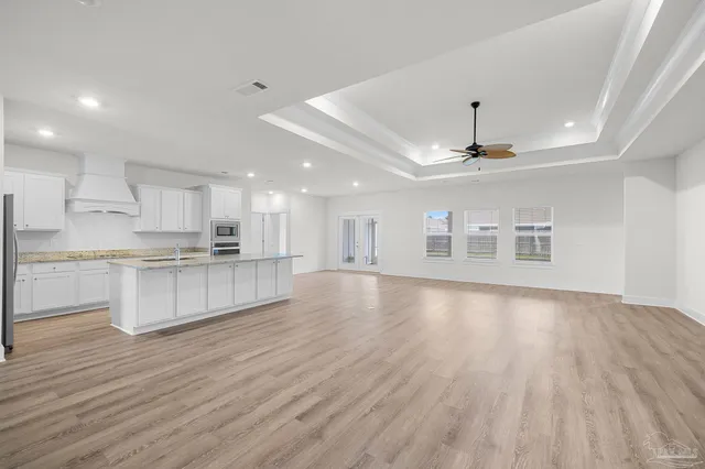a view of kitchen with sink microwave and refrigerator