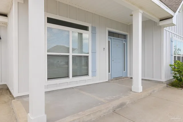 a view of an entrance to house with yard