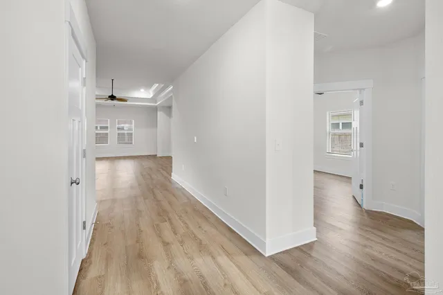 a view of a hallway with wooden floor
