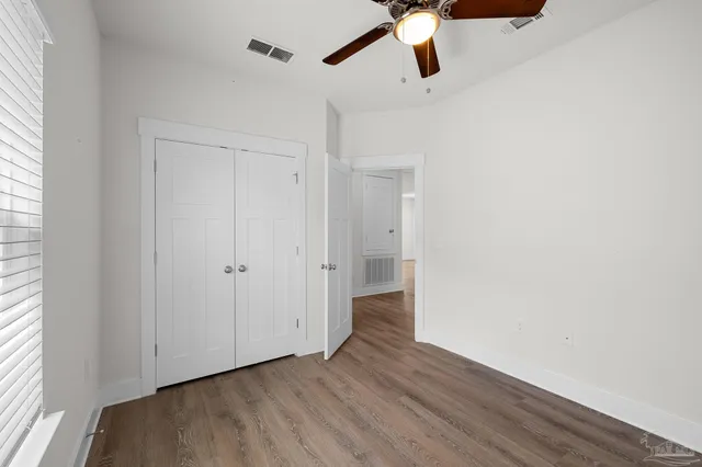 a view of an empty room and wooden floor