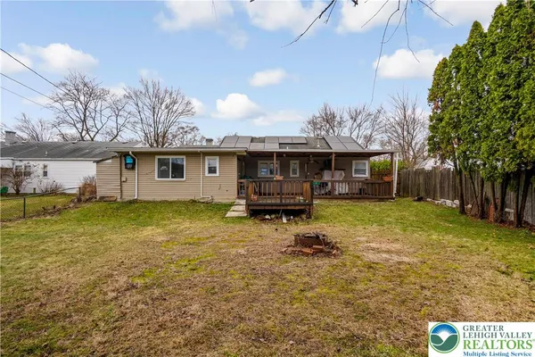 a backyard of a house with barbeque oven table and chairs
