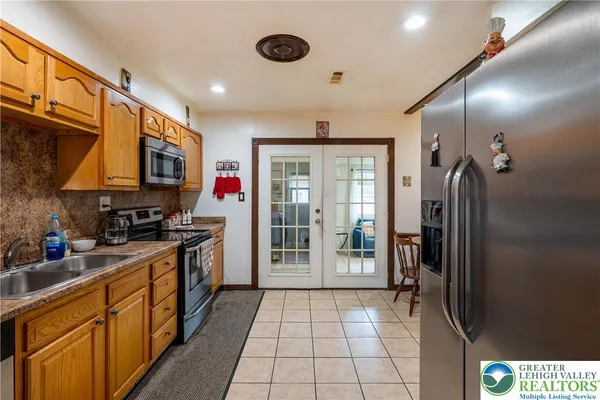 a kitchen with stainless steel appliances granite countertop a refrigerator and a stove
