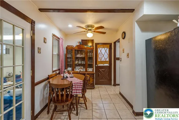 a view of a dining room with furniture and chandelier fan