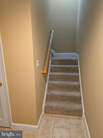 a view of staircase with white walls