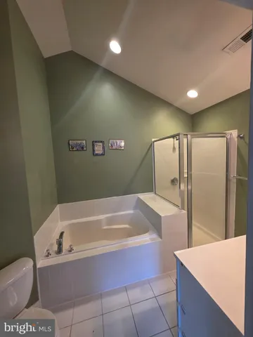 a spacious bathroom with a bathtub and shower