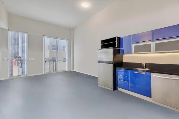 a kitchen with granite countertop a stove and a refrigerator