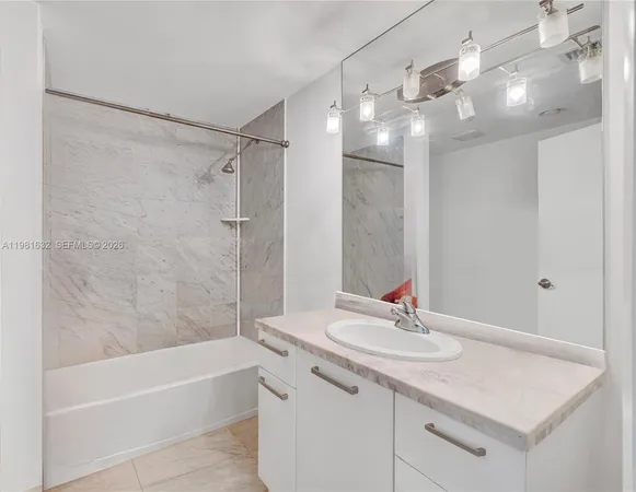 a bathroom with a sink double vanity granite tub shower and a mirror