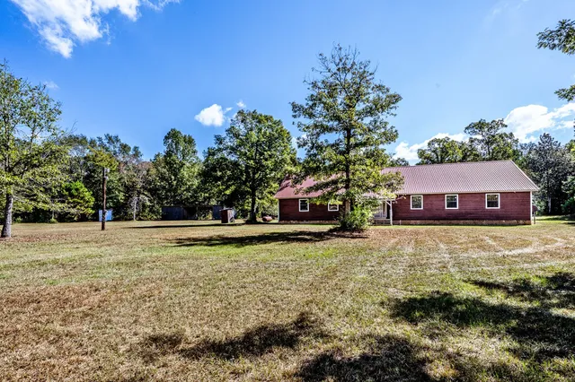 a swimming pool with outdoor seating and yard