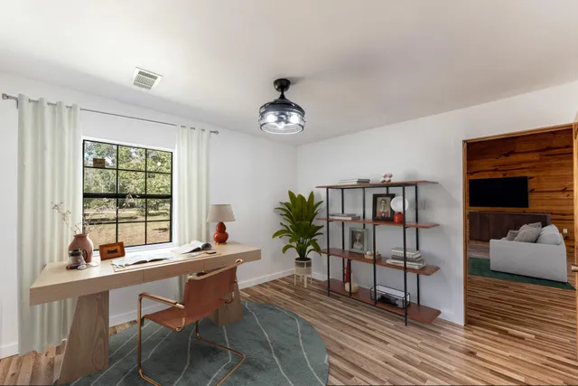 a bedroom with a bed and wooden floor