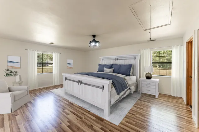 a bedroom with bed and a chair