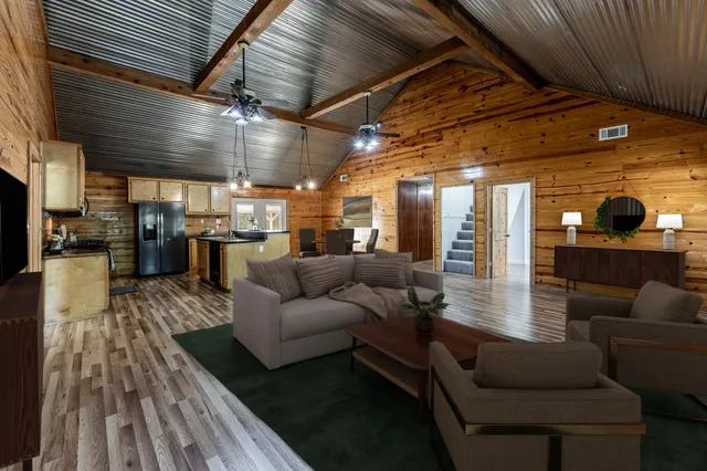 a kitchen with stainless steel appliances granite countertop a stove and a wooden floors