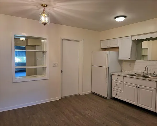 a view of a kitchen with a sink cabinets and wooden floor