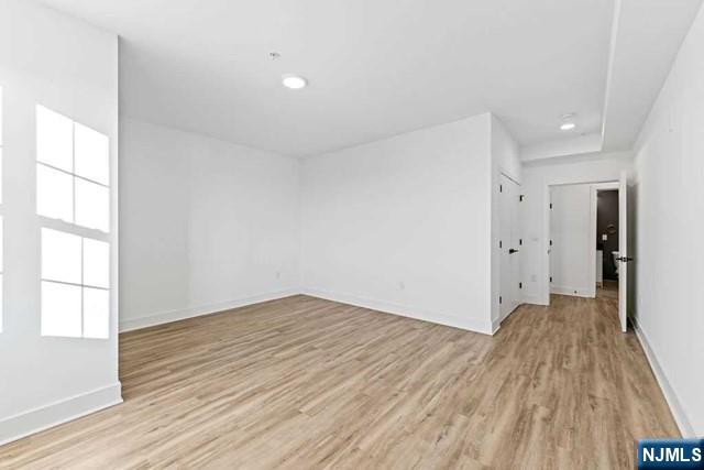 520 Cliff Street, Unit 103 Fairview, NJ 07022 - Photo 11 of 22 wooden floor in an empty room with a window