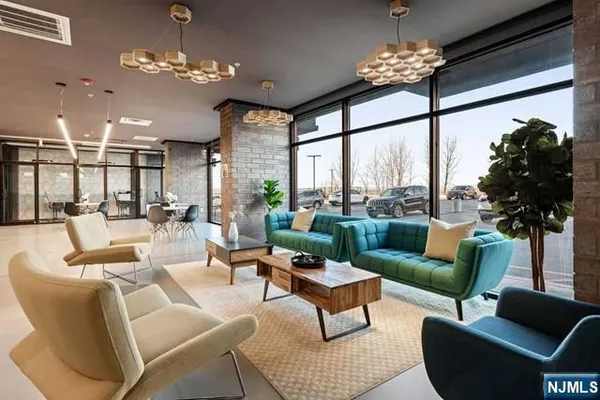 a living room with furniture chandelier and a large window