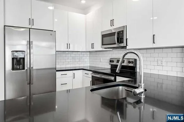 a kitchen with a refrigerator and a sink