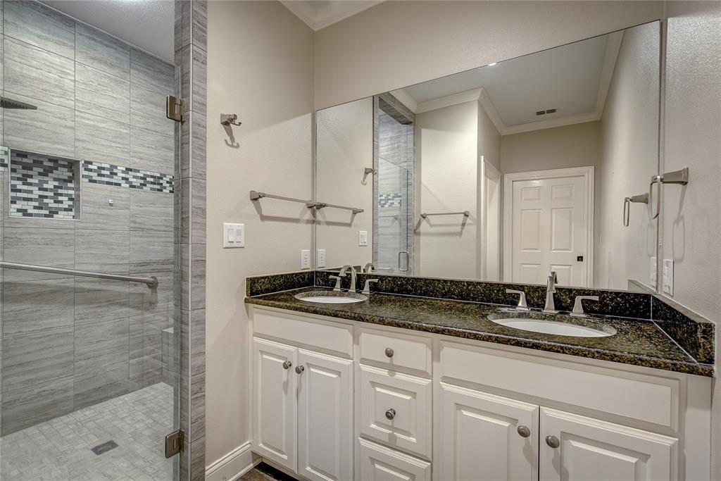 7359 Highway 154 Sulphur Springs, TX 75482 - Photo 21 of 40 downstairs primary bath has fully-tiled oversized shower with glass door, double vanity with granite, separate potty.