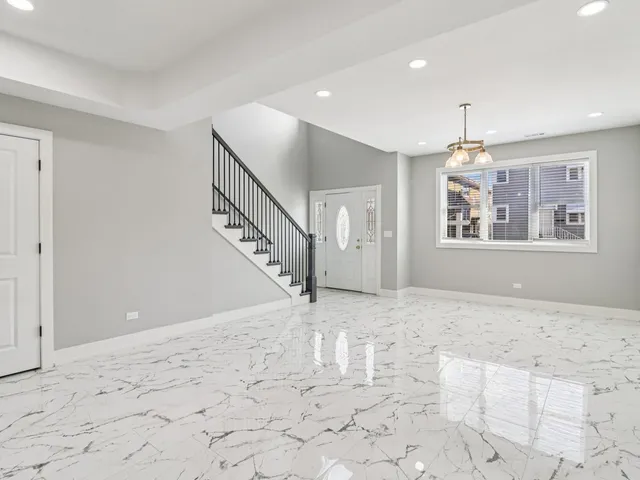 a large kitchen with kitchen island a sink stainless steel appliances and cabinets