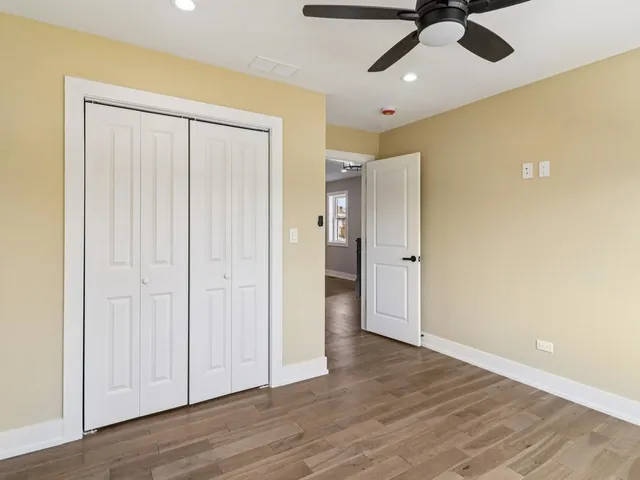 a bathroom with a granite countertop sink a toilet and a mirror