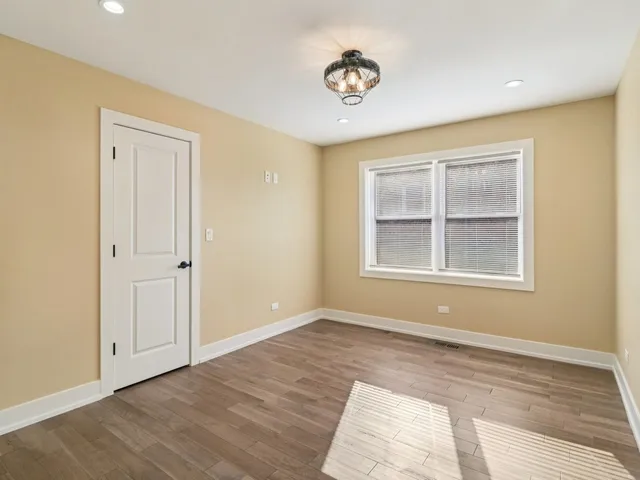 a view of a room with wooden floor and chandelier