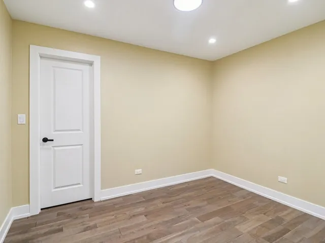 an empty room with wooden floor