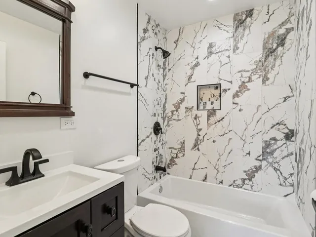 a bathroom with a toilet and a shower curtain