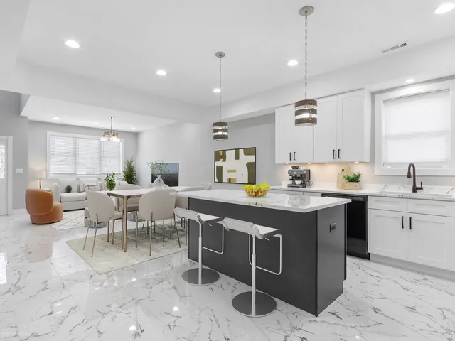 a kitchen with a sink dining table and chairs