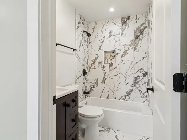 a view of a hallway with wooden floor and stairs