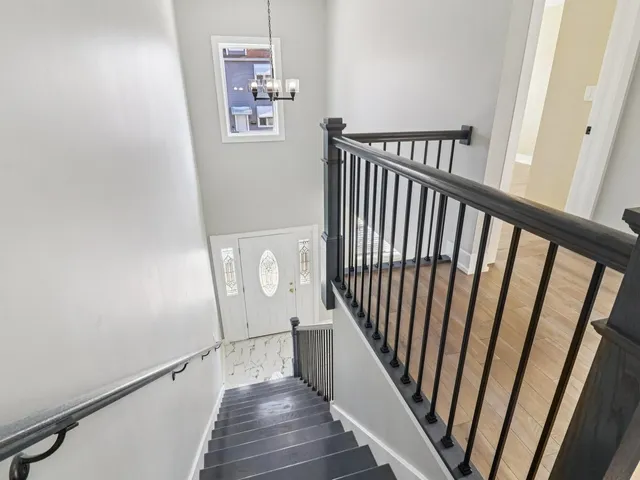 a bathroom with a granite countertop toilet sink and mirror