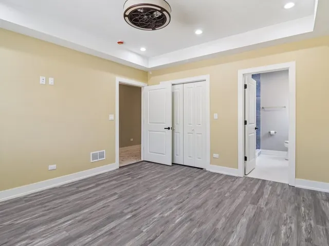 a bathroom with a granite countertop toilet a sink and a mirror