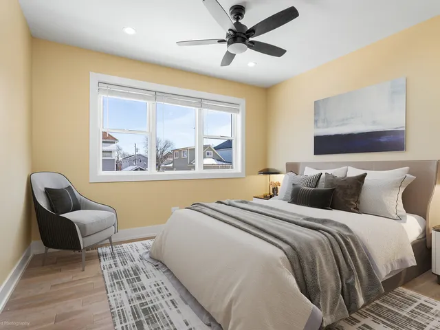 a view of a hallway with wooden floor and stairs