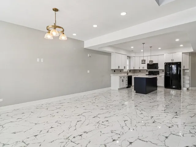 a view of a livingroom with wooden floor and staircase