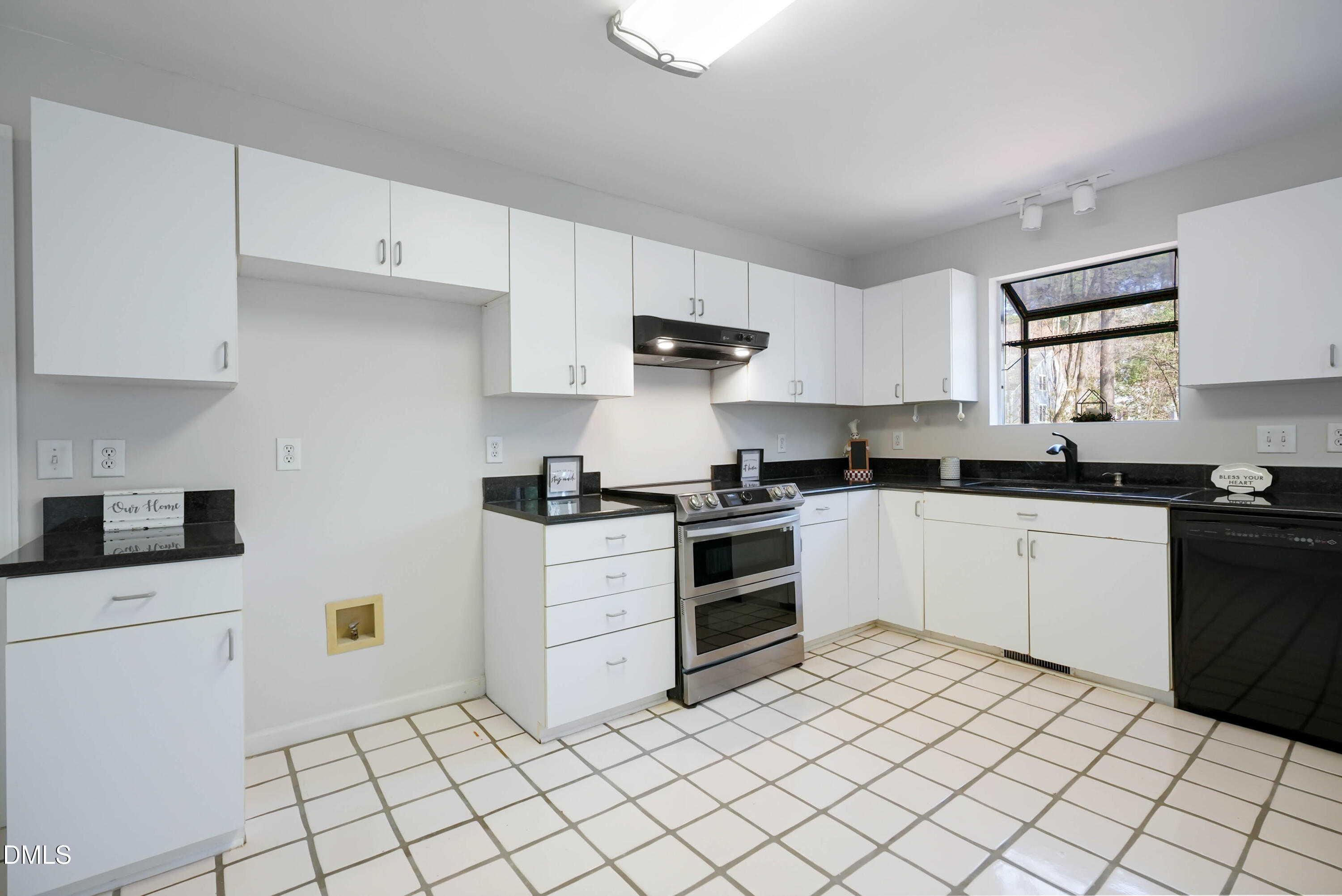 1500 Surfbird Court Raleigh, NC 27615 - Photo 12 of 47 a kitchen with granite countertop white cabinets and white appliances