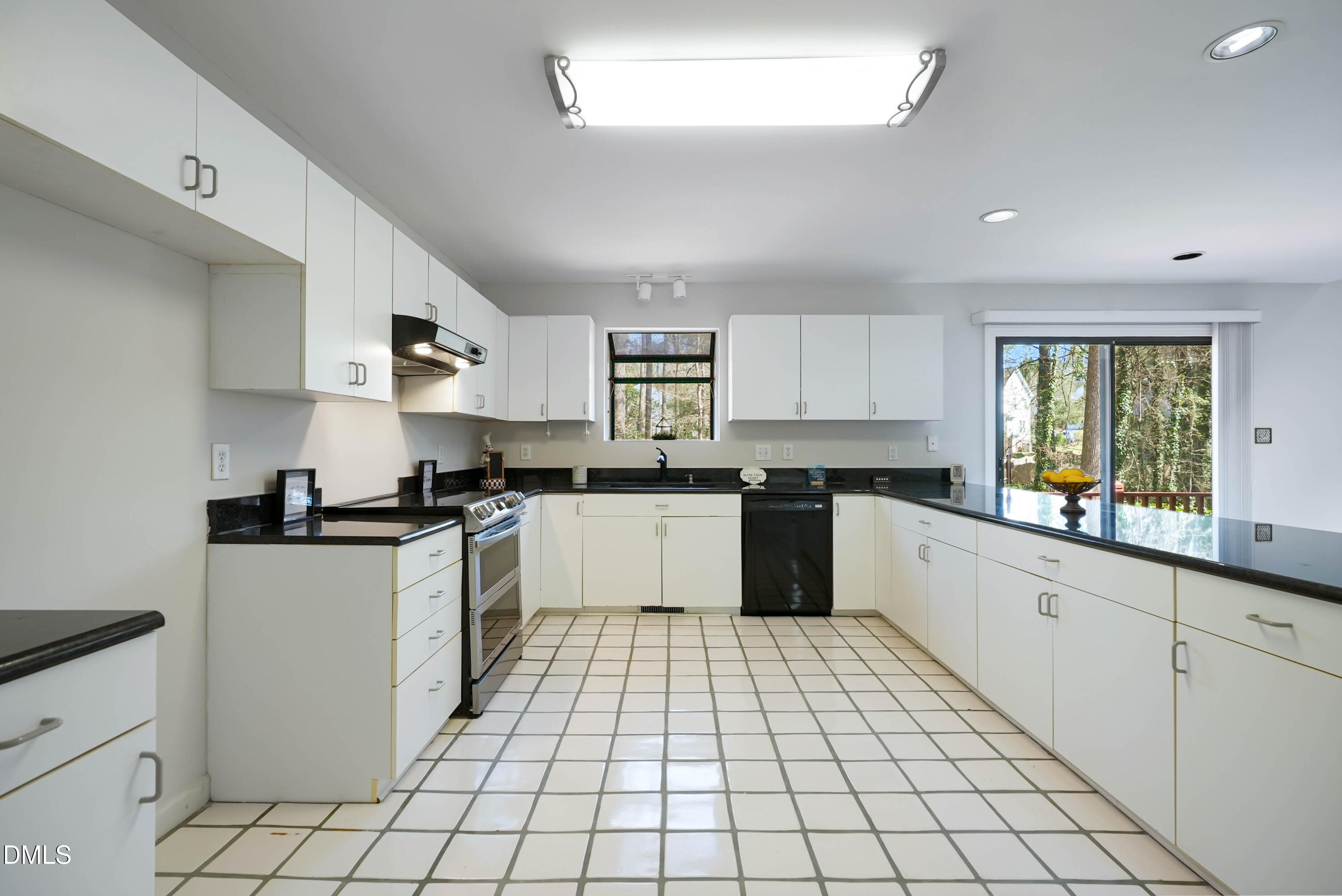 1500 Surfbird Court Raleigh, NC 27615 - Photo 17 of 47 a large white kitchen with a stove top oven a sink dishwasher and a refrigerator